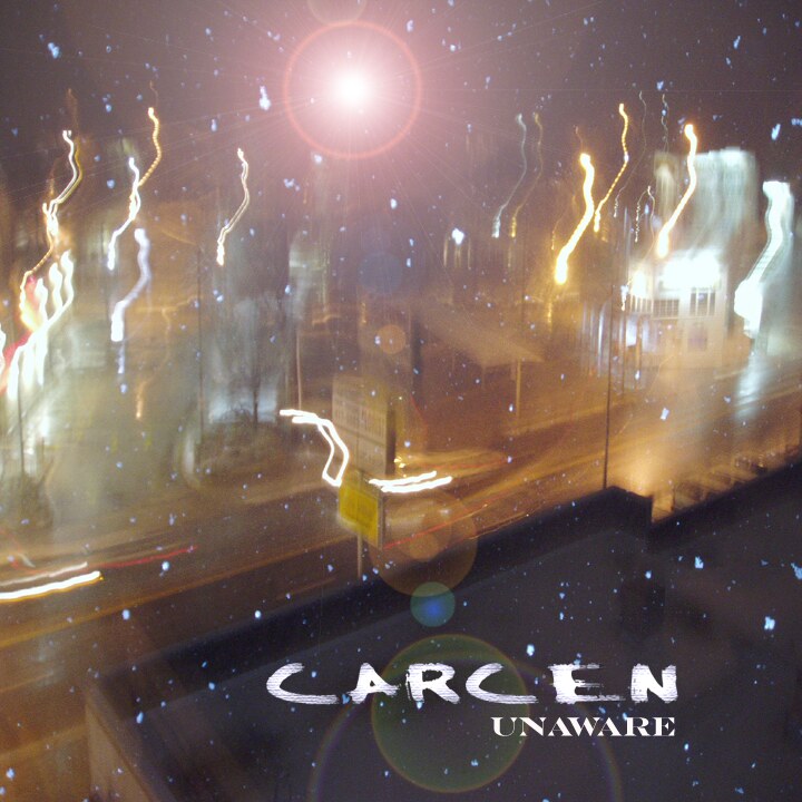 Cover art for Carcen's 2005 album Unaware: blurred city lights at night